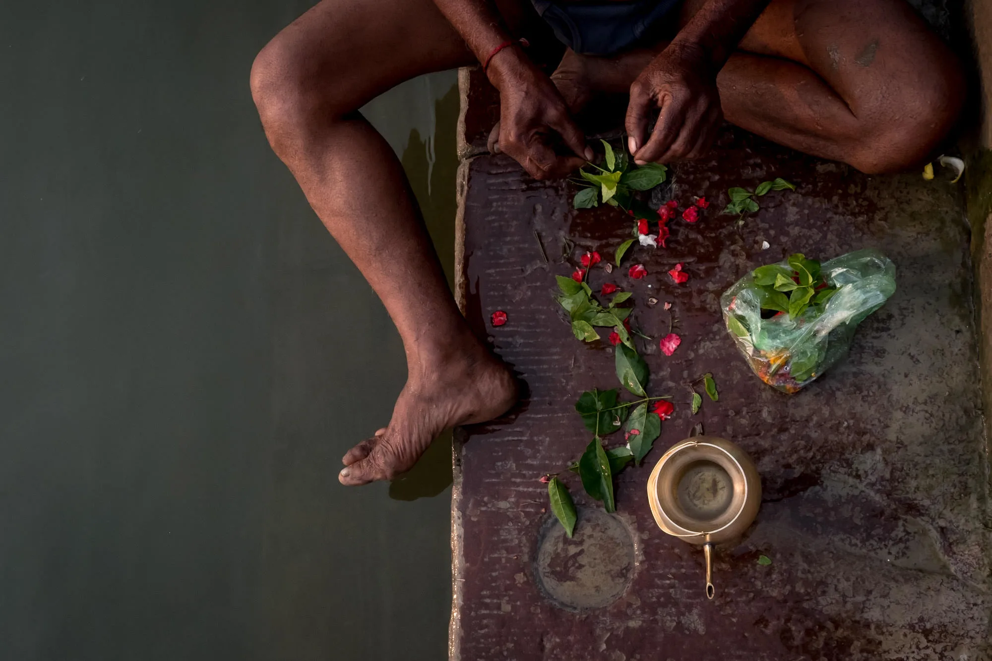 man preparing indian ritual in Varanasi by the water