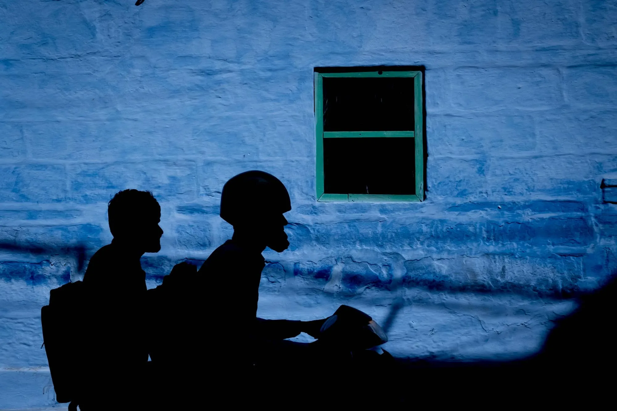 motorbike silhouette against blue wall taken on India street photography trip