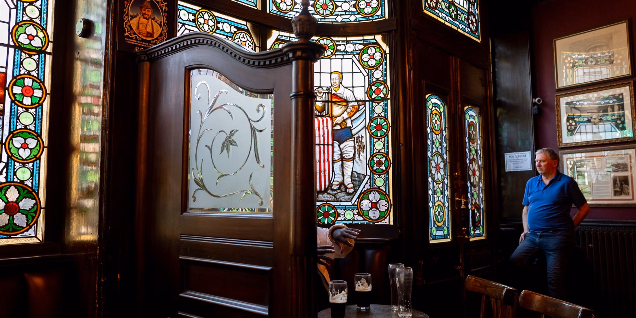 street photo take in a London pub with stained glass windows