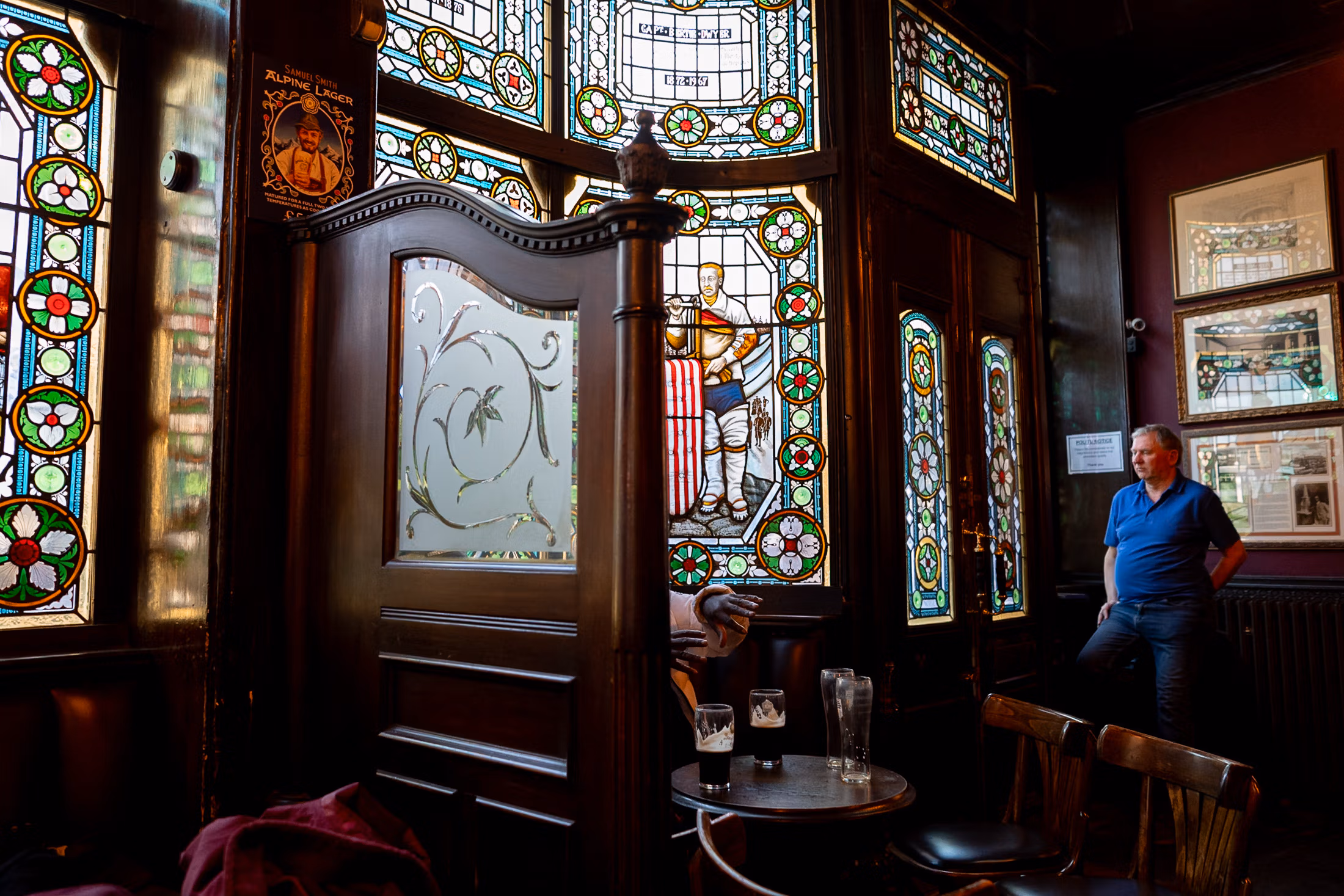 street photo take in a London pub with stained glass windows